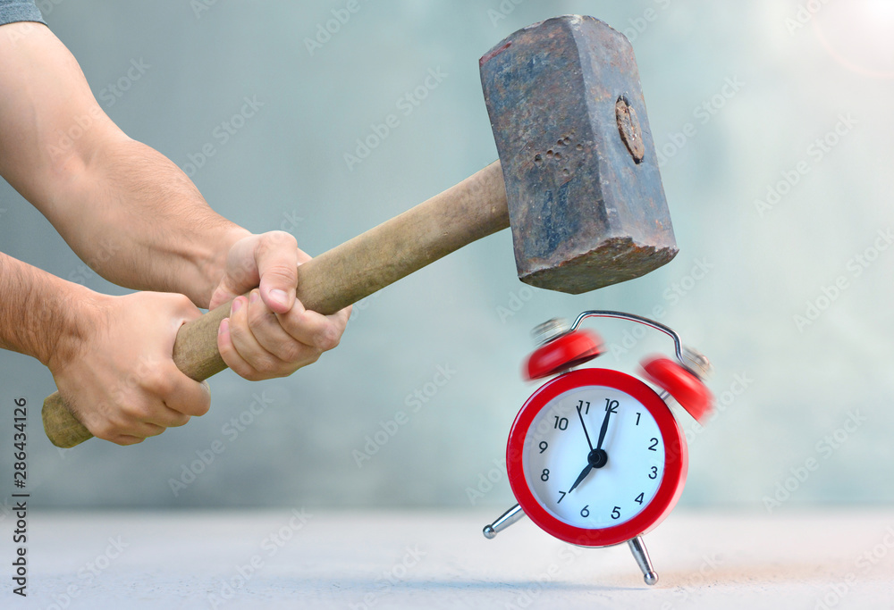 Early awakening with ringing alarm clock. Man with big hammer going to  destroy morning alarm clock. Concept of breaking rules. Stock Photo | Adobe  Stock
