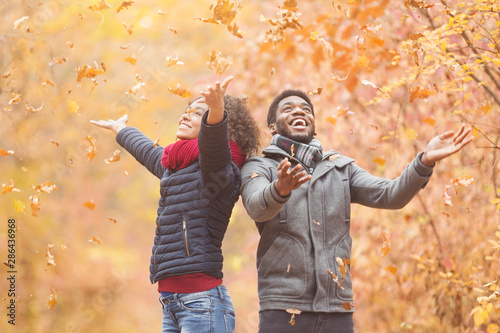 African-american couple spending fun time in autumn park photo