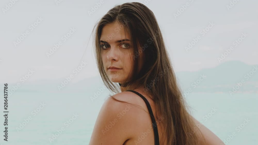 Beautiful girl looking in the camera lake garda and mountains sirmione veneto italy August 2019 Beautiful girl looking in the camera lake garda and mountains sirmione veneto italy August 2019