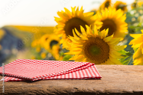 Empty wooden plank with Sunflower field background