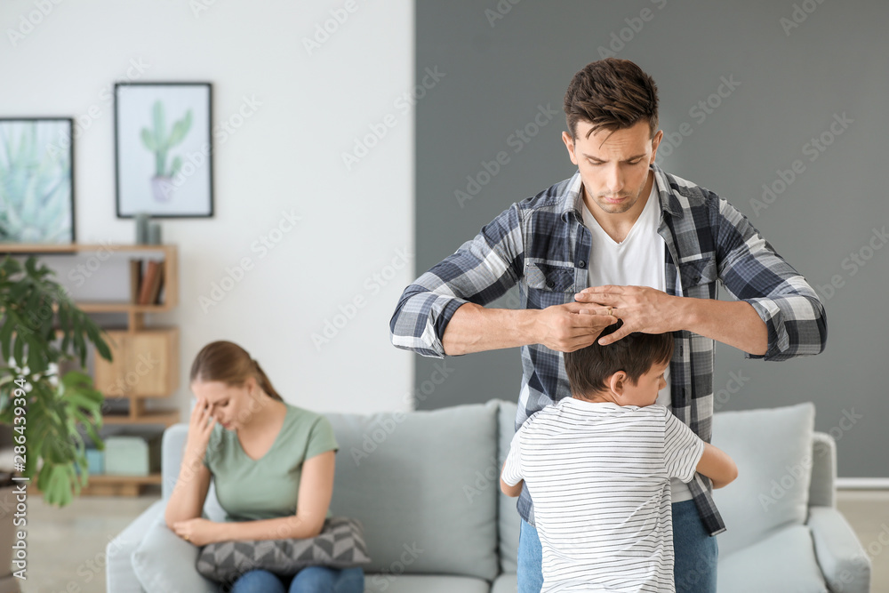 Little boy hugging his father who is taking off wedding ring. Concept of divorce Little boy hugging his father who is taking off wedding ring. Concept of divorce