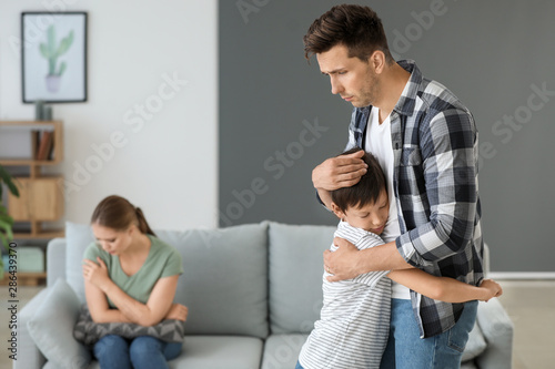 Man calming his son after f...