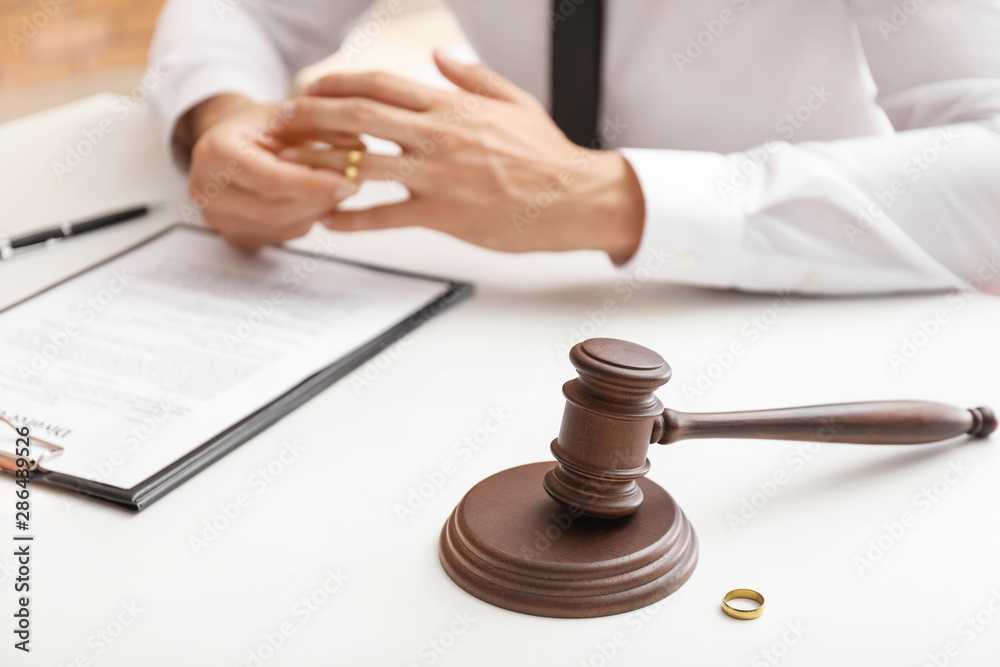 Judge gavel on table in lawyer's office. Concept of divorce Judge gavel on table in lawyer's office. Concept of divorce