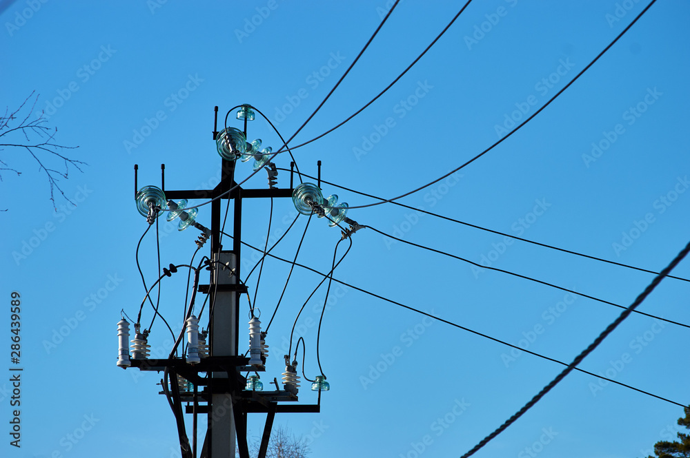 electric power wires and glass caps on the top of the long industrial pole electric power wires and glass caps on the top of the long industrial pole