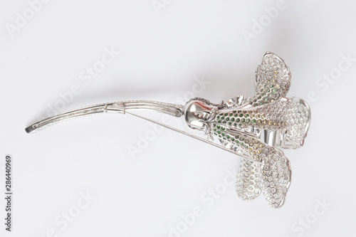 flower shaped brooch on whtie background