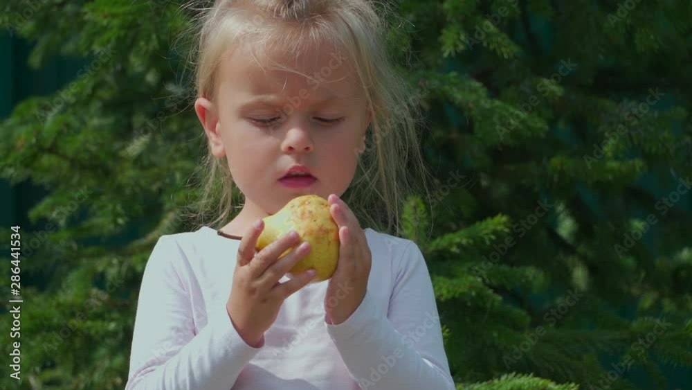 Pretty girl eating a pear Pretty girl eating a pear