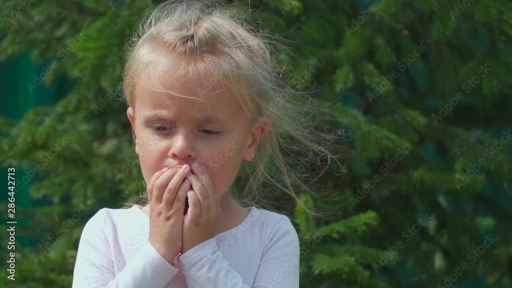Happy little girl eating plum outdoors. Concept of healthy food. Happy little girl eating plum outdoors. Concept of healthy food.