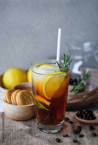 Americano iced coffee with lemon and rosemary for healthy drinking 