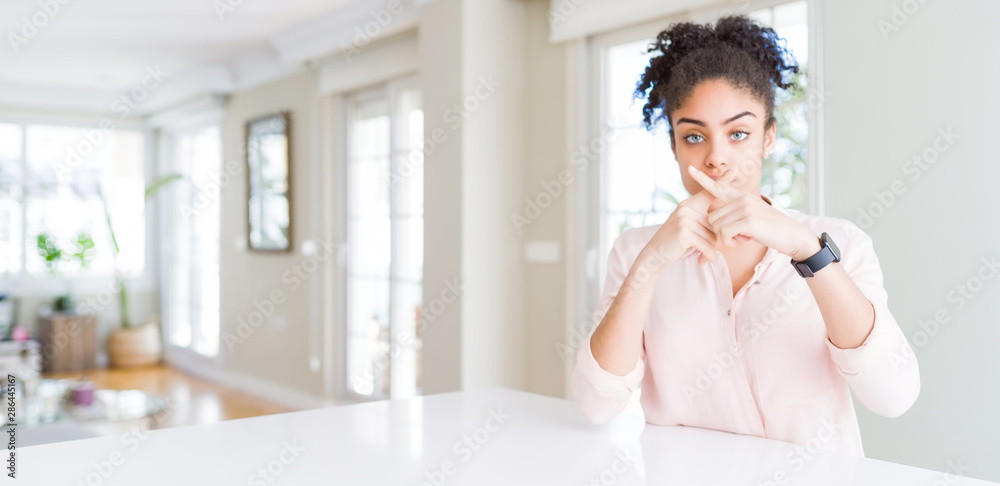 Wide angle of beautiful african american woman with afro hair Rejection expression crossing fingers doing negative sign Wide angle of beautiful african american woman with afro hair Rejection expression crossing fingers doing negative sign