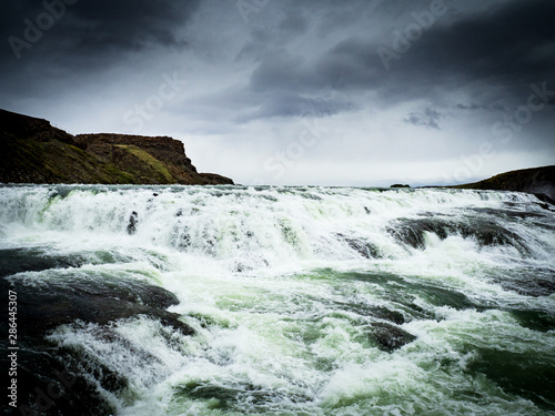 Gullfoss waterfall with dark clouds in Iceland