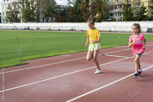 Front view of girls running on track