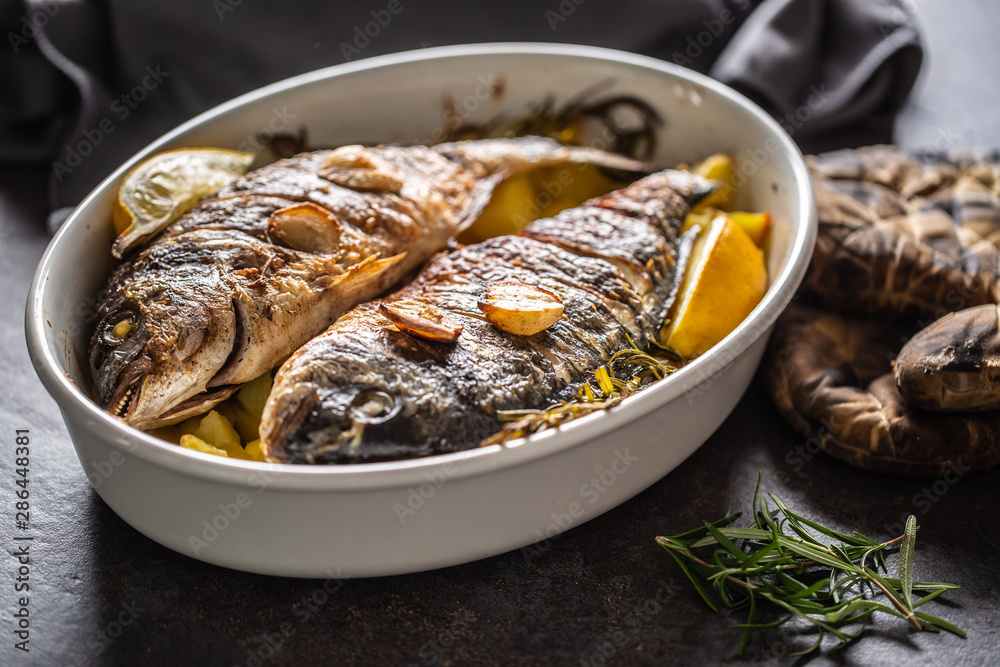 Roasted mediterranean fish bream with potatoes rosemary and lemon Roasted mediterranean fish bream with potatoes rosemary and lemon