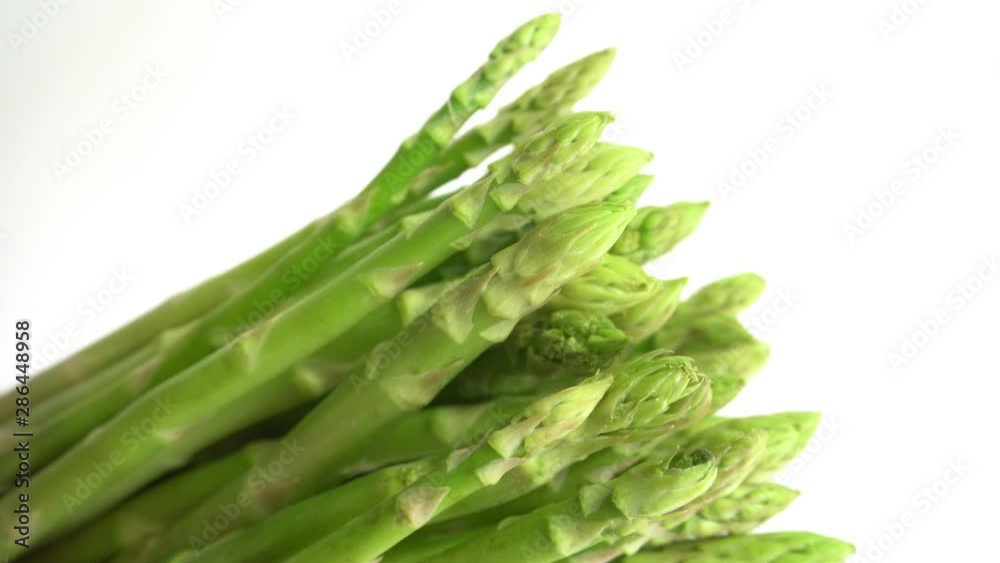 Green asparagus on white background , Close-up and panning camera Green asparagus on white background , Close-up and panning camera