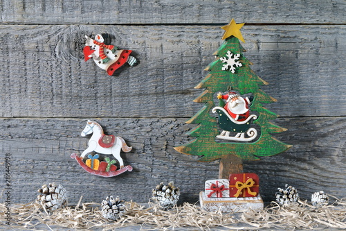 Composition of Christmas and New Year bright decorations made of plywood is on a gray wooden background. 
