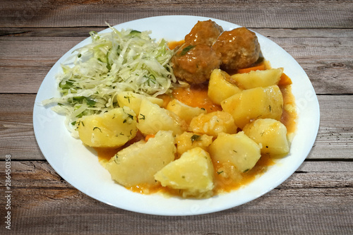 Meatballs - pork, beef, potatoes and salad on plate