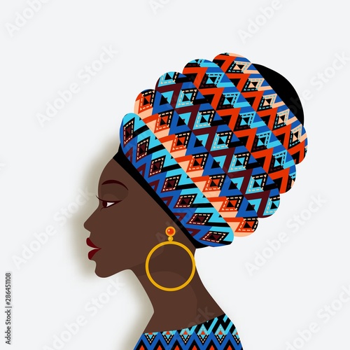 African woman in scarf and earrings in profile