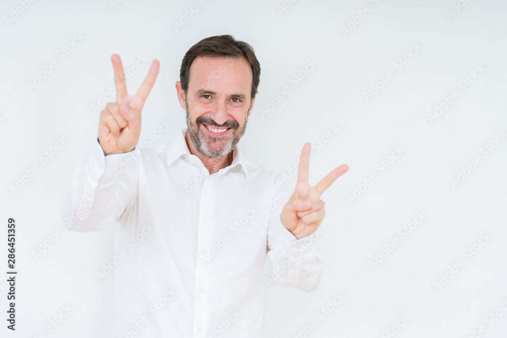 Elegant senior man over isolated background smiling looking to the camera showing fingers doing victory sign. Number two. Elegant senior man over isolated background smiling looking to the camera showing fingers doing victory sign. Number two.