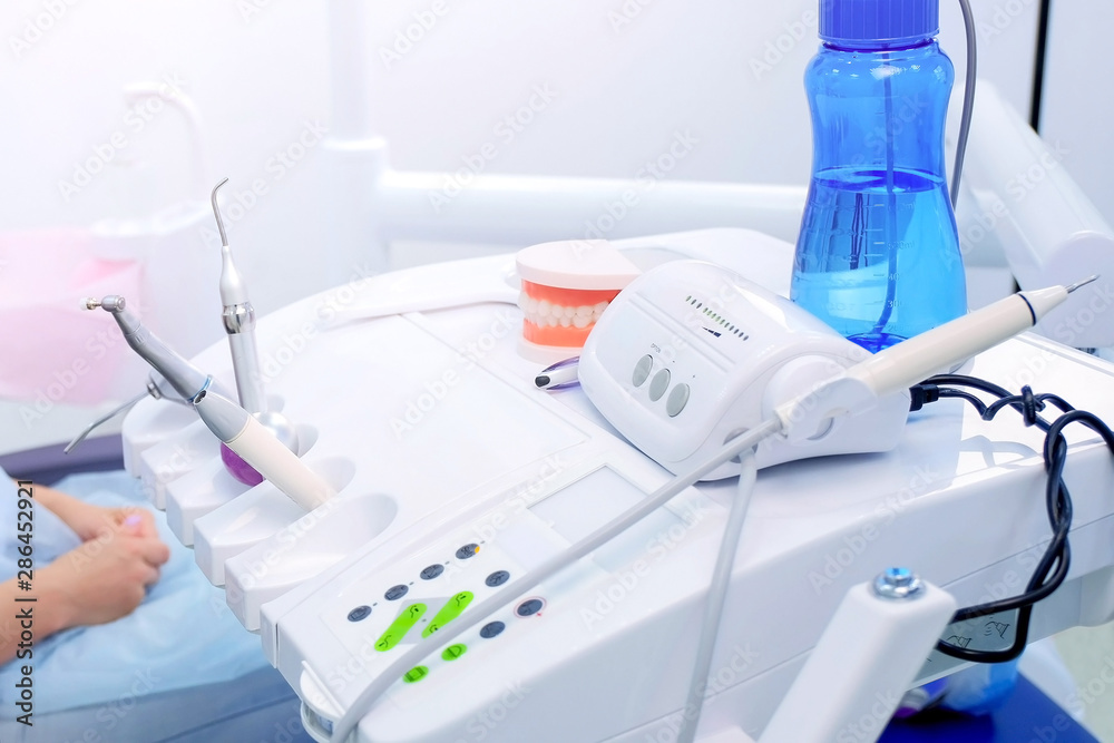 Stomatologist at work in dentistry. Woman dentist uses medical equipment in stomatology clinic for cure, hands closeup. Treatment, cure teeth pocedure patient office medicine. Stomatologist at work in dentistry. Woman dentist uses medical equipment in stomatology clinic for cure, hands closeup. Treatment, cure teeth pocedure patient office medicine.