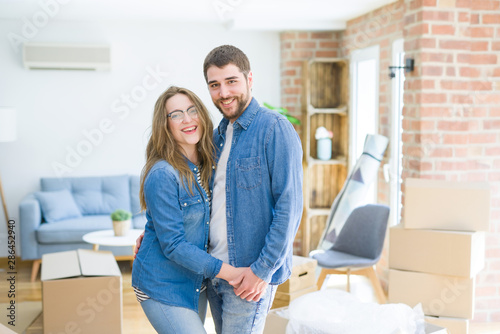 Young couple around cardboard boxes very happy moving to a new home © Krakenimages.com