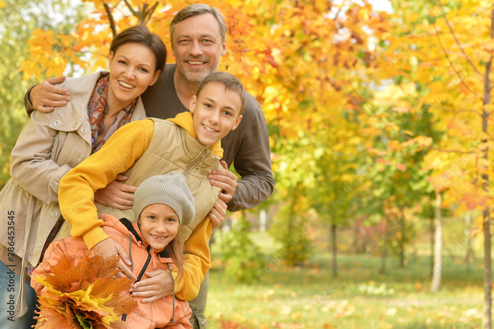 Portrait of happy family in autumn park Portrait of happy family in autumn park