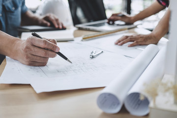 Construction and structure concept of Engineer or architect meeting for project working with partner and engineering tools on model building and blueprint in working site