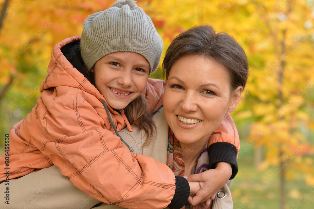 Close up portrait of mother and daughter hugging Close up portrait of mother and daughter hugging