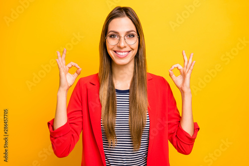 Portrait of her she nice-looking attractive lovely winsome cheerful cheery glad content satisfied straight-haired lady showing two double ok-sign isolated over bright vivid shine yellow background