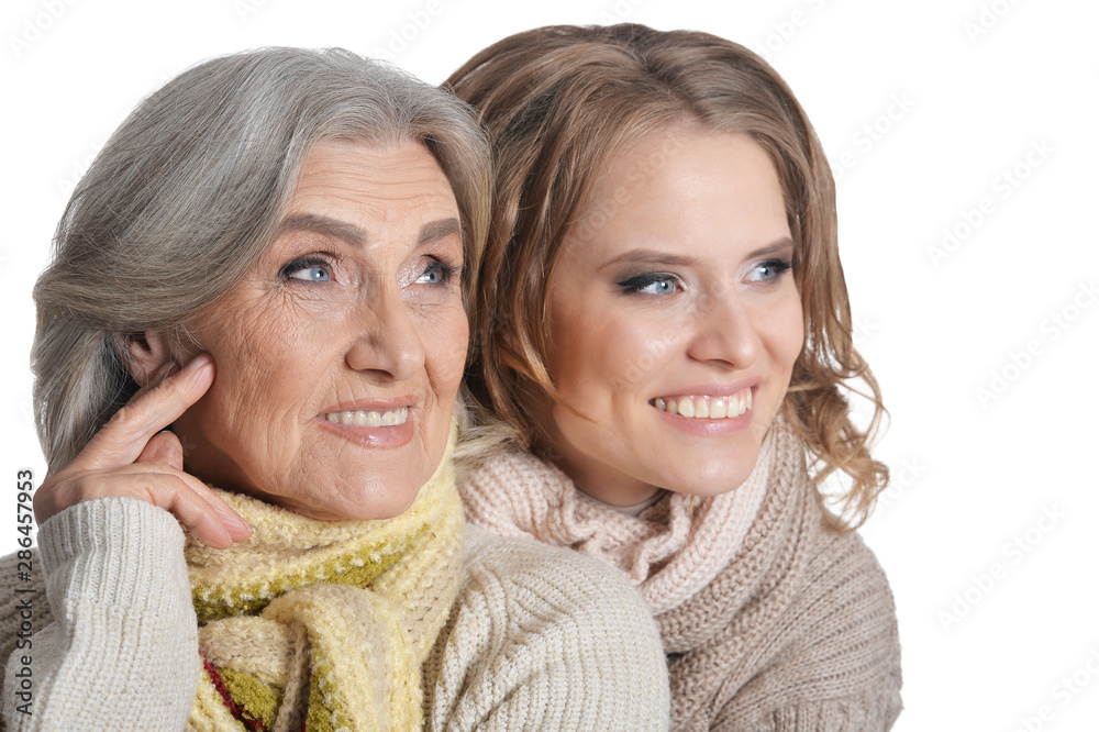 close up portrait of mother and her adult daughter hugging