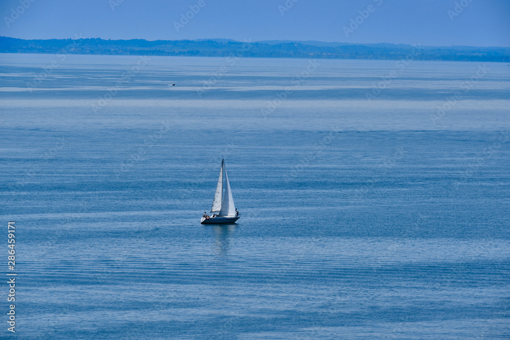 sailing yacht on blue water top view