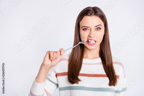 Wallpaper Mural Pretty lady can't stand keeping to diet biting metal spoon wear striped pullover isolated white background Torontodigital.ca