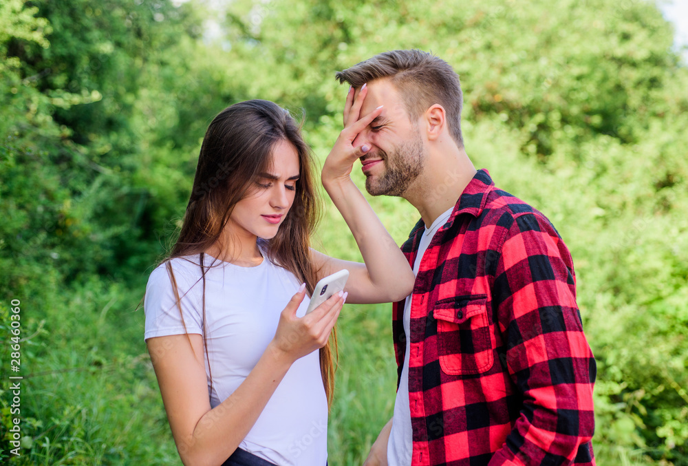 Fototapeta premium Man jealous girlfriend messaging online. Buy online. Internet dependence. Guy and girl nature smartphone. She always online. Woman use mobile phone. Mobile addicted. Social networks. Surfing internet