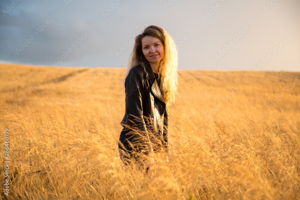 Blonde beautiful girl portrait in the golden field. Blonde beautiful girl portrait in the golden field.