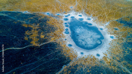 Aerial view of animal tracks near a dried-up waterhole in the Okavango Delta in Botswana in the dry season