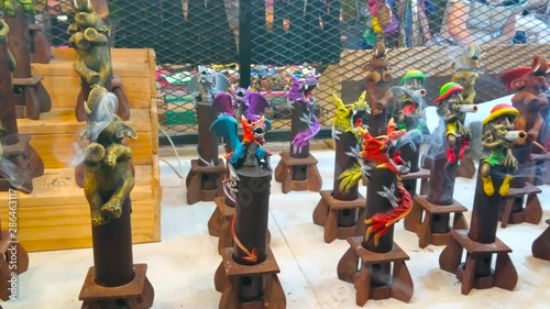 Handmade incense censers with figurines of rastaman, chameleon, elephant, dragon and other characters on the counter of souvenir stall in Chiang Mai Night Market, Thailand photo