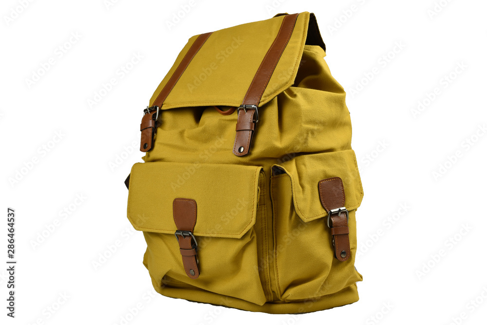 Canvas Backpack accessories isolated hipster background white. brown with yellow mustard canvas bag. Hand made backpack for travelers. Side view Canvas Backpack accessories isolated hipster background white. brown with yellow mustard canvas bag. Hand made backpack for travelers. Side view