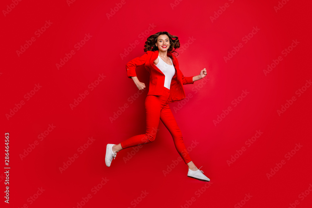 Full length photo of cheerful girl running having bright lips stick isolated over red background Full length photo of cheerful girl running having bright lips stick isolated over red background