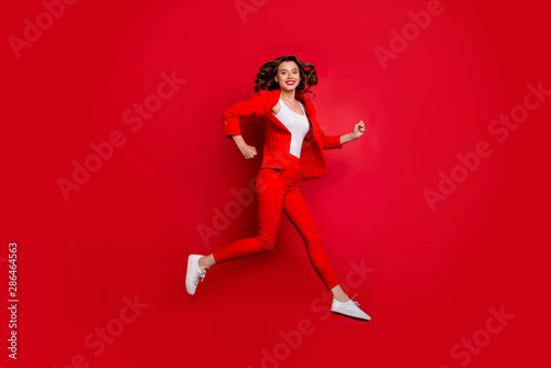 Full length photo of cheerful girl running having bright lips stick isolated over red background