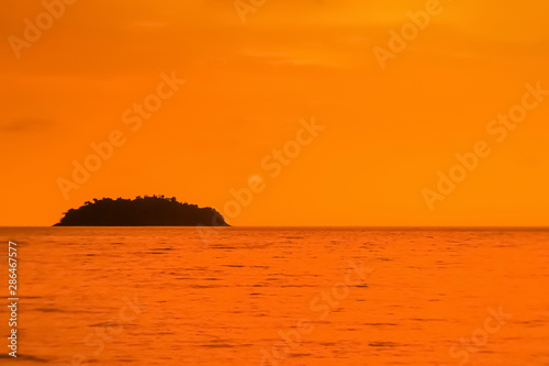 view of small island with orange sea and sky background, sunset at Kai Bae Beach, Koh Chang island, Trat, Thailand.