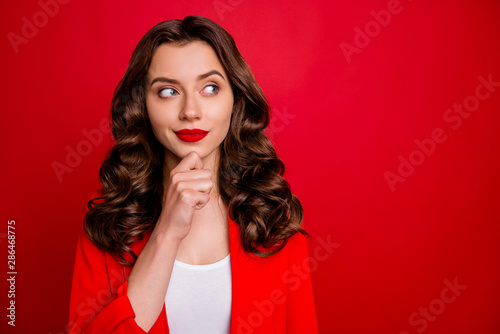 Photo of pretty lady look sly empty space wear formal wear red jacket isolated burgundy background photo