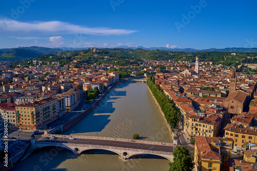 Adige river and fortified medieval castle of Castelvecchio. Aerial drone panoramic photo from city of Verona. Verona, Italy.