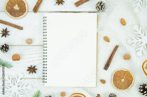 Top view Christmas and New Year background with notepad and decorations. To do list or list of promises, copy space for your text. Flat lay mock up