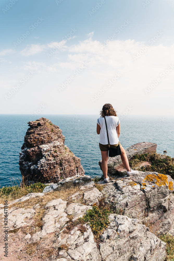 Beautiful woman looking at seascape in Brittany