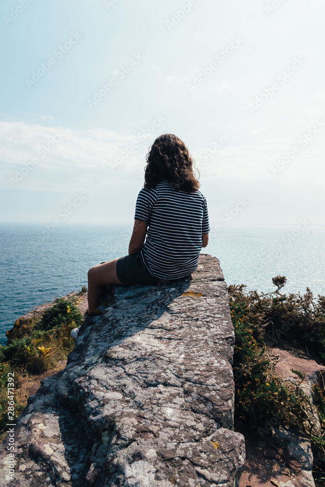 Beautiful woman looking at seascape in Brittany Beautiful woman looking at seascape in Brittany