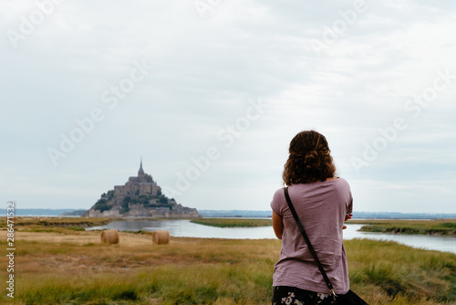 Rear view of woman watching Mont Saint-Michel