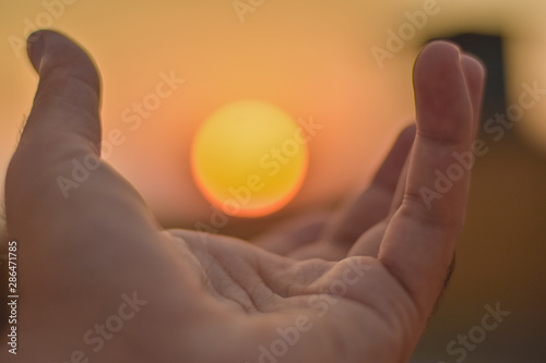 sun on male hand. Playing with sun