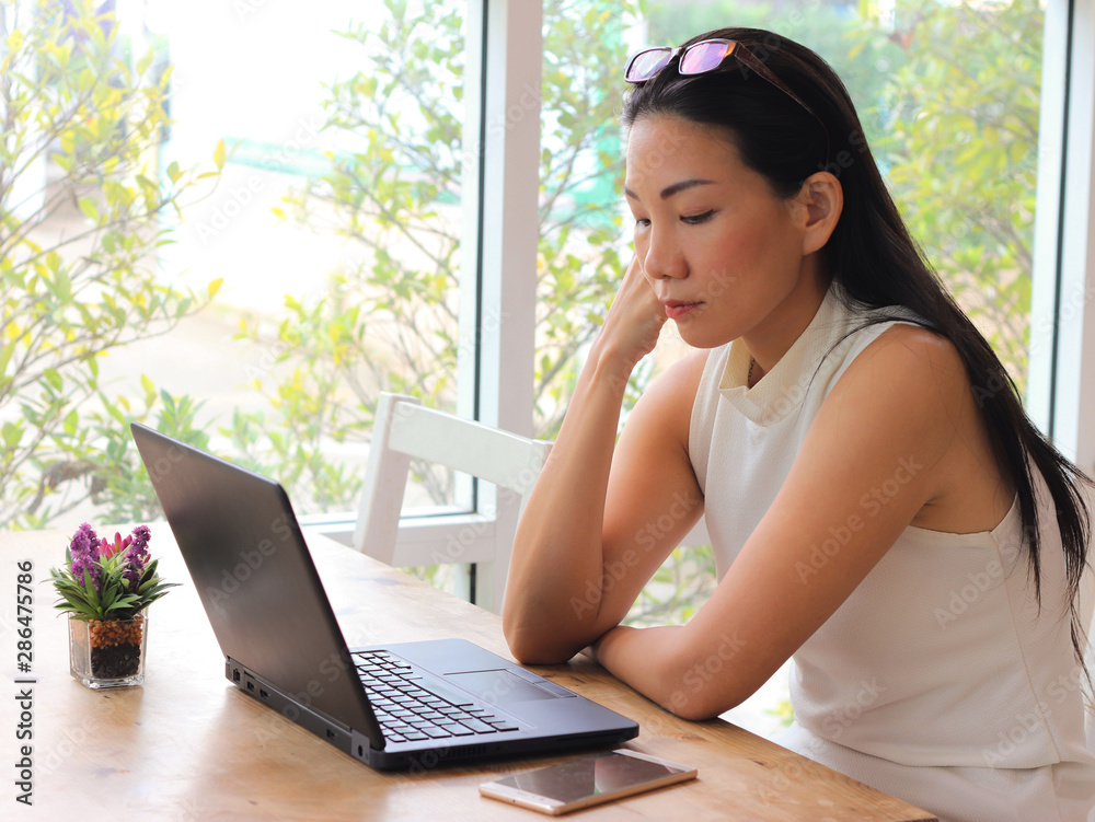Asian woman sit with computer laptop look worried and stressed. Asian woman sit with computer laptop look worried and stressed.