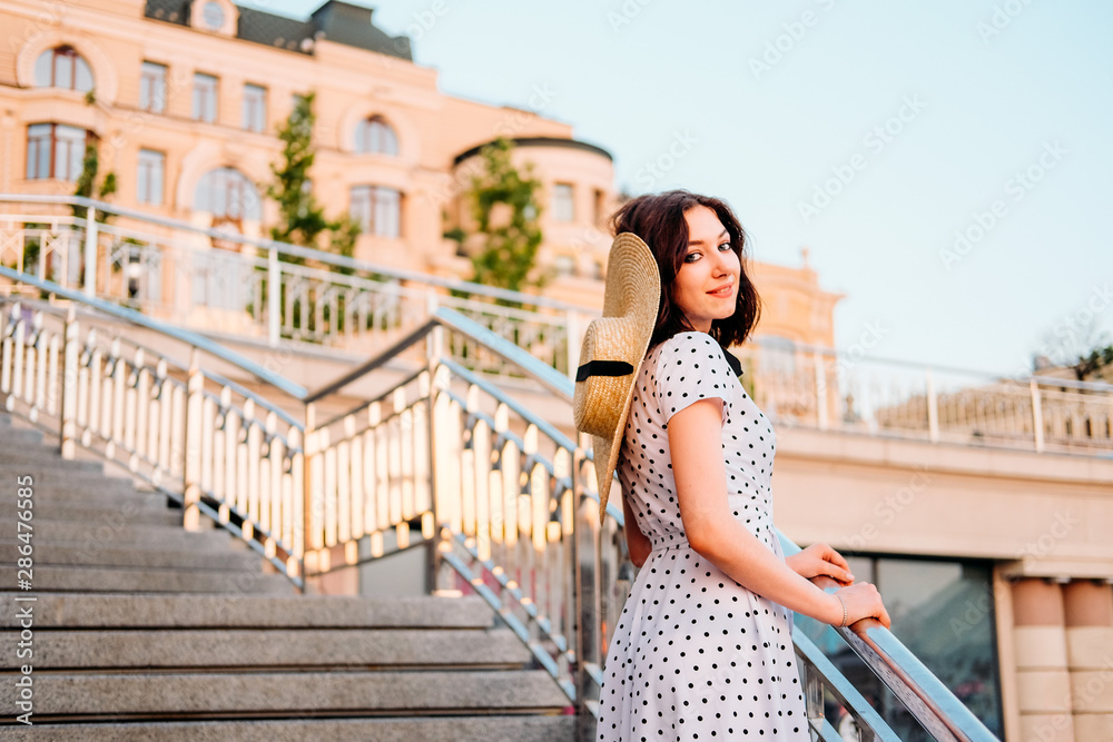 Elegant young lady walking outdoors in the city