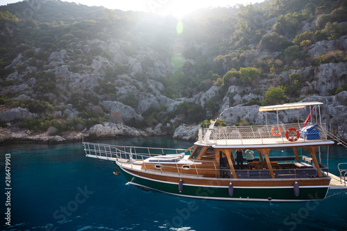 Powerboat. View from the boat. Mediterranean sea overlooking the mountains. Aerial top view of sea waves hitting rocks on the beach with turquoise sea water.