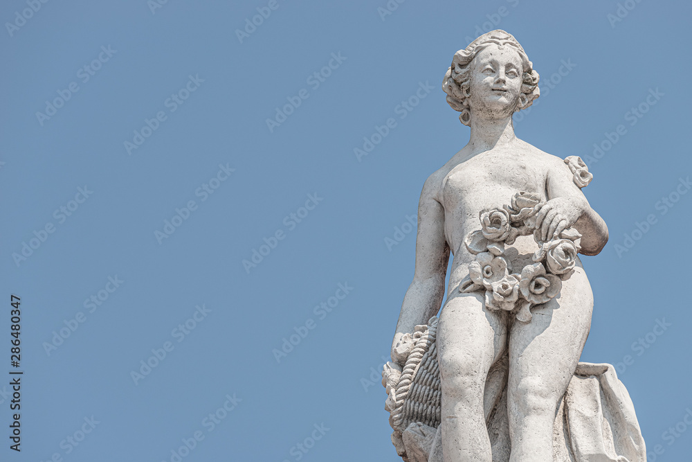 Ancient top roof statue of sensual Italian Renaissance and Rococo Era naked woman in Potsdam at blue sky, Germany Ancient top roof statue of sensual Italian Renaissance and Rococo Era naked woman in Potsdam at blue sky, Germany