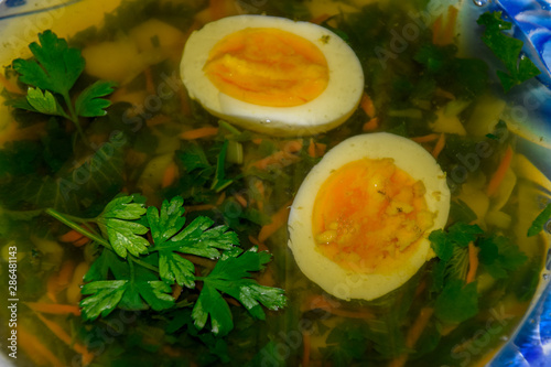 Soup with boiled egg and parsley photo